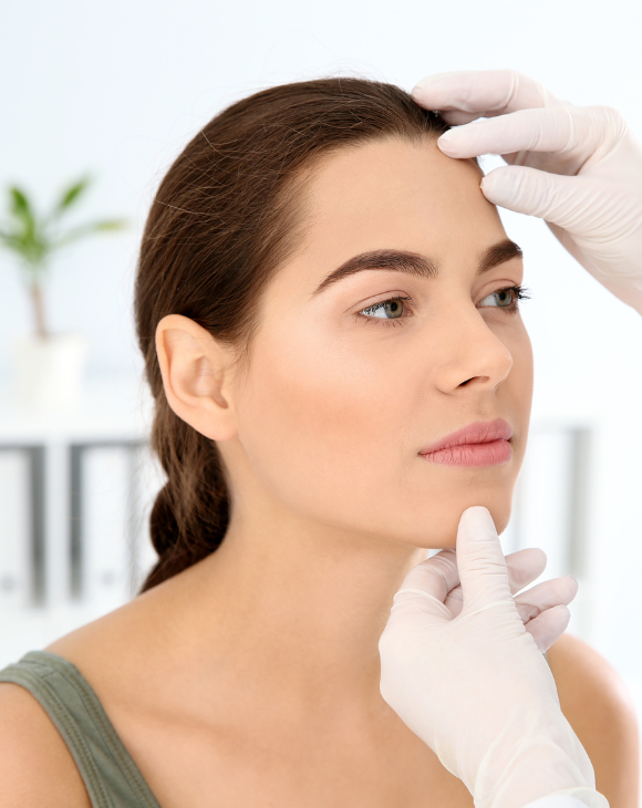 Doctor examining a female patient's face